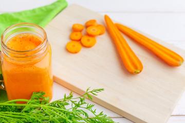 Carrot smoothie with parsley on a table