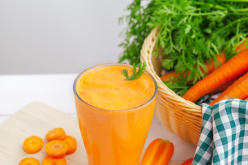 Glasses of carrot juice with vegetables on table close up