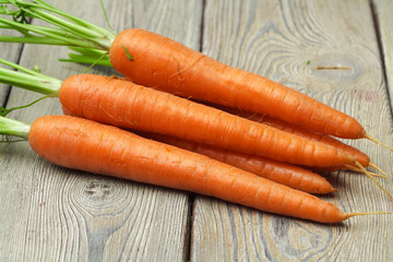 Close up of fresh carrot on rustic wooden background