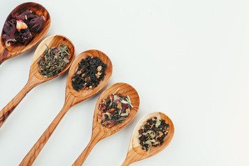 leaf  tea in a wooden spoon isolated on white background