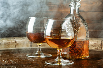 Cognac or whiskey in glasses on rustic backgrpund