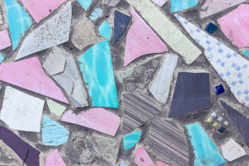 Colorful ceramic fragments and cement floor
