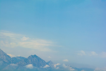Sea view on peaks of Taurus Mountains covered by low clouds and fog from boat. Travel concept. Soft...