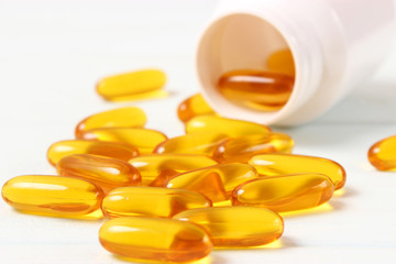 Omega-3 capsules on a colored background. Fish oil, healthy supplements