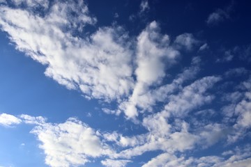 Beautiful white fluffy cloud formations on a deep blue sky