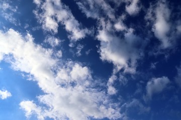 Beautiful white fluffy cloud formations on a deep blue sky