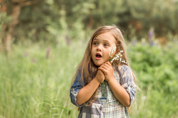 girl with lily of the valley in nature