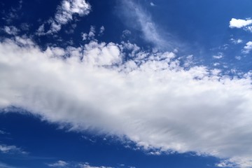 Beautiful white fluffy cloud formations on a deep blue sky