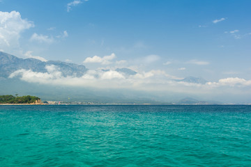 Fototapeta na wymiar Sea view on Taurus Mountains covered by low clouds and Mediterranean sea from boat. Travel concept.