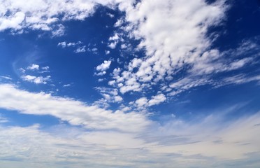 Beautiful white fluffy cloud formations on a deep blue sky