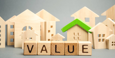Wooden blocks with the word Value and wooden houses. Property valuation and housing. The best value...