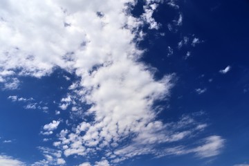 Beautiful white fluffy cloud formations on a deep blue sky