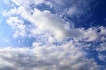 Beautiful white fluffy cloud formations on a deep blue sky