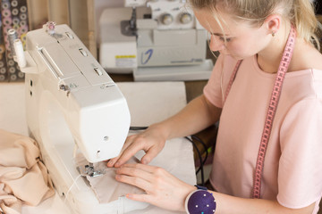 woman sews tailor fashion designer sewing machine beautiful