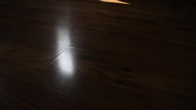 Time-lapse, sunshine makes shadows on wooden floors through wooden blinds