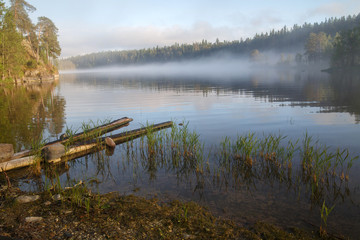 Fototapeta na wymiar Foggy morning landscape on the lake, Valaam Island, Karelia, Russia.