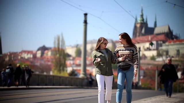 Two young women walking on the streets of Prague