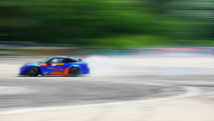Sport car wheel drifting. Motion blurred of image diffusion race drift car with lots of smoke from burning tires on speed track. - 274250098