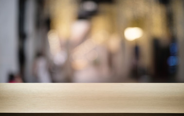 Empty dark wooden table in front of abstract blurred bokeh background of restaurant . can be used for display or montage your products.Mock up for space.