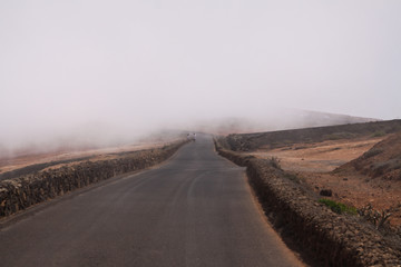 Mirador del Rio - Lanzarote: Scenic curved road on high mountain peak viewpoint above clouds
