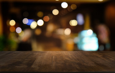 Empty dark wooden table in front of abstract blurred bokeh background of restaurant . can be used for display or montage your products.Mock up for space.