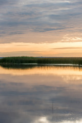 Fototapeta na wymiar A Still Lake in Rural Latvia at Sunset