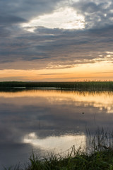 Fototapeta na wymiar A Still Lake in Rural Latvia at Sunset