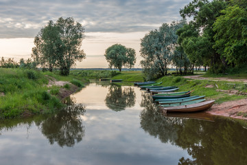 Fototapeta premium Small Fishing Boats on a Canal at a Lake in Latvia
