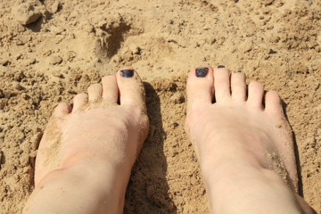 feet on the sand summer time