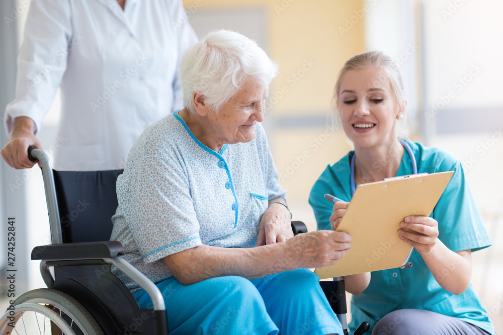 Wall mural doctor talking to her patient in hospital