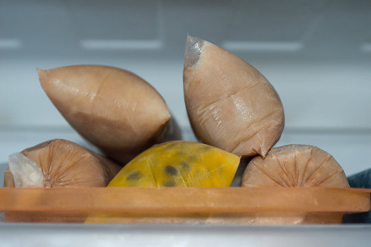 frozen sweet brazilian ice candy, name geladinho, chupchup, sacole or dindin, made with chocolate and passion fruit - ice cream in the bag