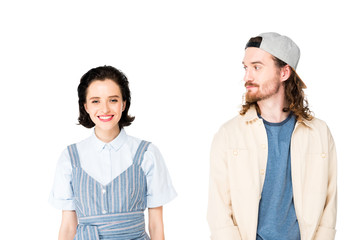 beautiful girl looking at camera and smiling while young man looking at girl isolated on white