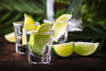 Cachaca - Brazilian strong alcoholic beverage from cane sugar, lime vodka, vintage wooden...