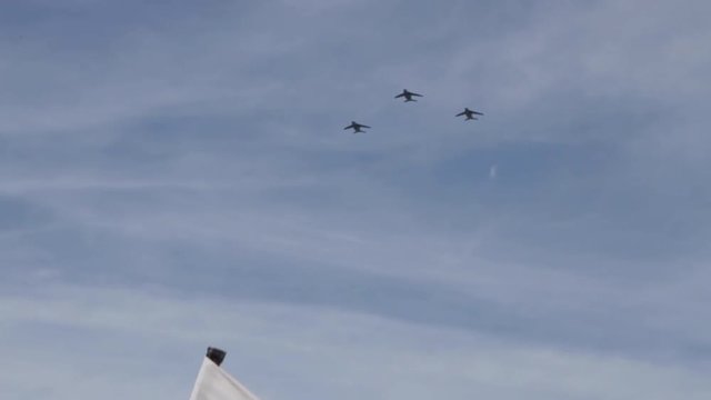 Three black military Fighter jets flying in the blue sky during the summer in the south of France.