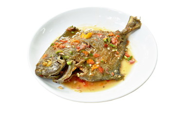 deep fried white pomfret dressing spicy sauce on plate