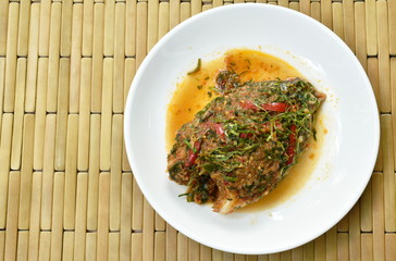 batter fried mango fish dressing spicy herb sauce on plate