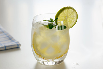 Mineral water with lemon in a steaming glass