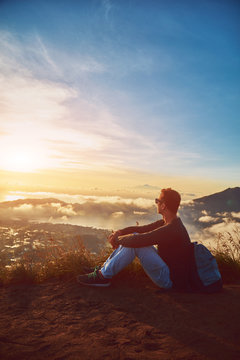 Man enjoying nice landscape from a top of mountain Batur, Bali, Indonesia. © astrosystem