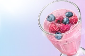 Glass of blueberry smoothie isolated on white background