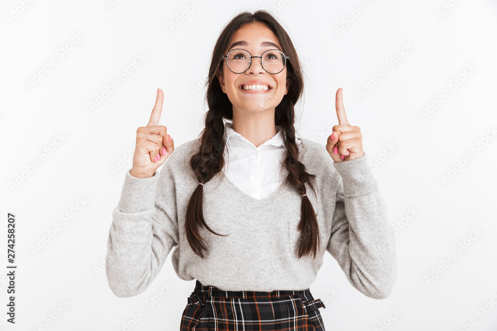 Sticker photo closeup of lovely teenage girl wearing eyeglasses smiling and pointing fingers upward at copys