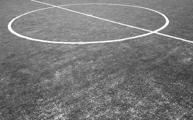 Fragment of footbal field with artificial grass in black and white.