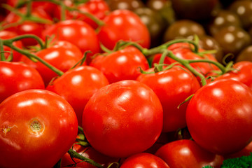 Bright red tomatoes on display at a farmers market stall