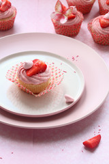 Strawberry Cupcakes with lemon curd filling, on light pink background.