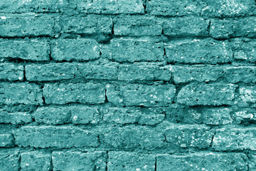 Old grungy brick wall texture in cyan tone.