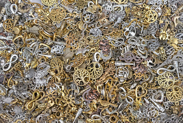 Pendants for chains of white and yellow metal. Background from metal pendants for design and decoration.