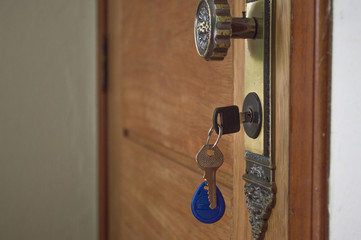 nfc rfid - keyring in door of house with blue tag for personal identification and automation of house