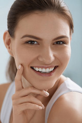 Smiling woman face with white teeth smile, clean skin portrait
