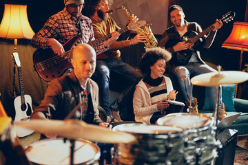 Fototapeta na wymiar Jazz band playing music in home studio. Selective focus on drummer.