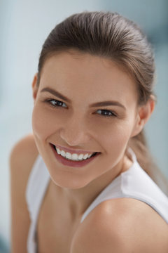 Smiling woman face with white teeth smile, clean skin portrait