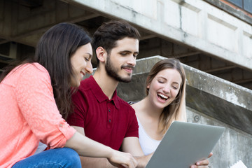 Group of  University students studying together outdoors